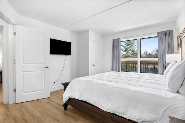 bedroom with light wood finished floors and baseboards