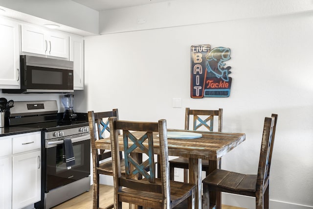 dining space featuring light wood-style flooring