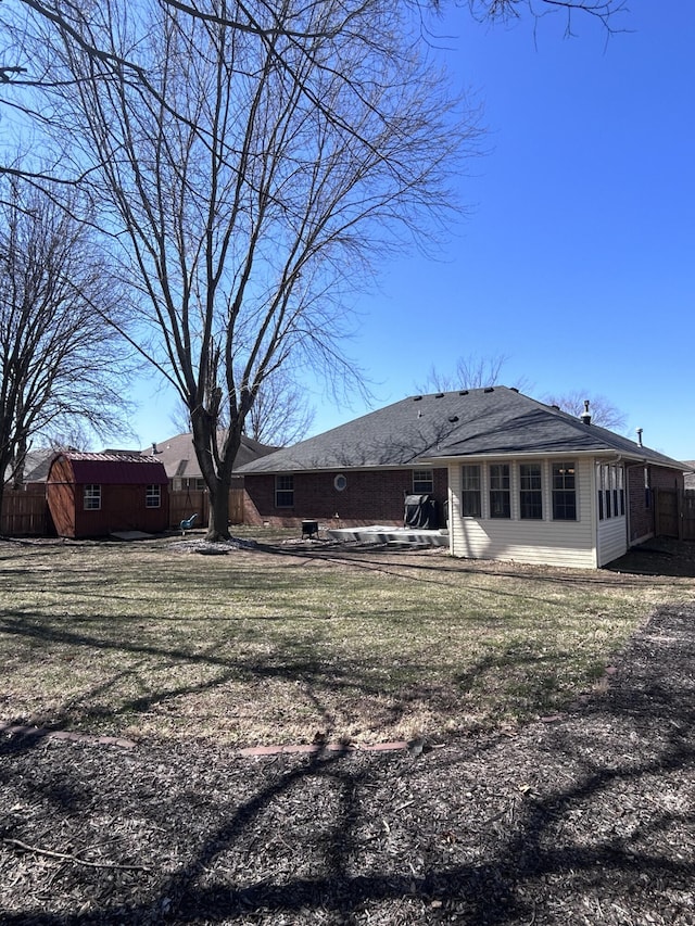 rear view of house featuring a yard, a patio, and fence