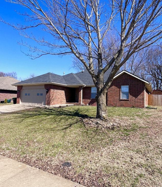 ranch-style home featuring fence, concrete driveway, a front yard, an attached garage, and brick siding