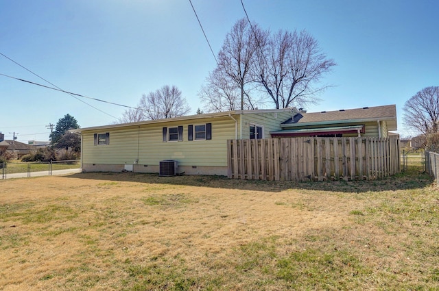 back of property featuring central air condition unit, a lawn, fence, and crawl space