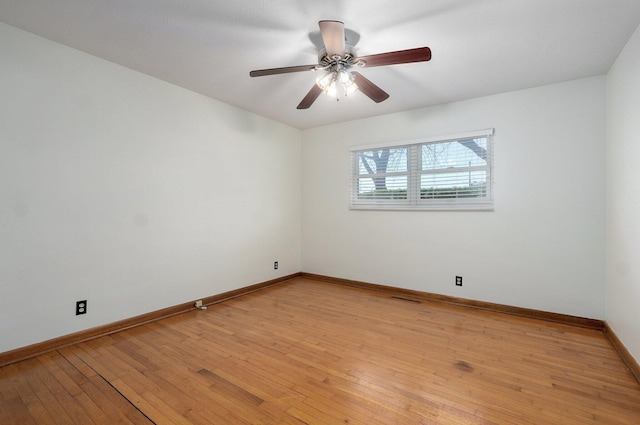 spare room with visible vents, baseboards, light wood-style floors, and ceiling fan