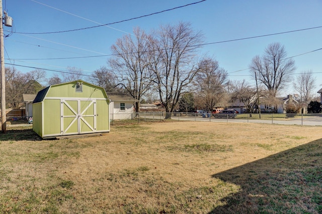 view of yard featuring fence, an outdoor structure, and a shed