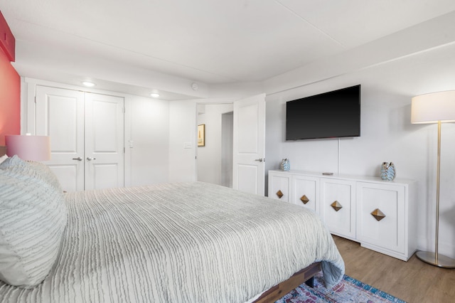 bedroom with a closet and wood finished floors