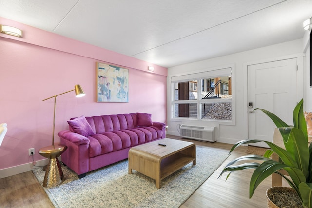 living area featuring baseboards and wood finished floors