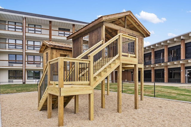 view of jungle gym featuring fence
