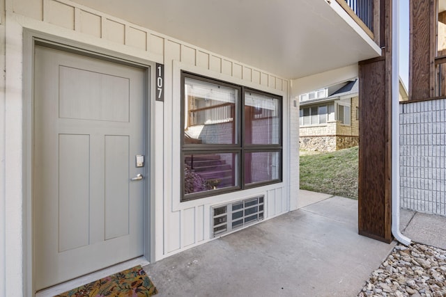 view of exterior entry with board and batten siding