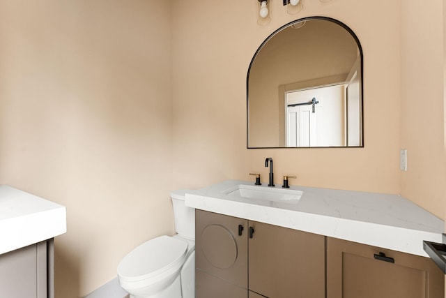 bathroom featuring toilet and vanity