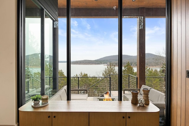 interior space with a water and mountain view