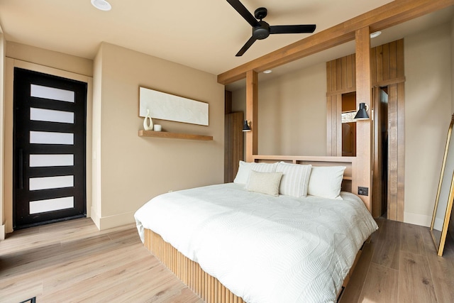 bedroom featuring baseboards, ceiling fan, and light wood finished floors