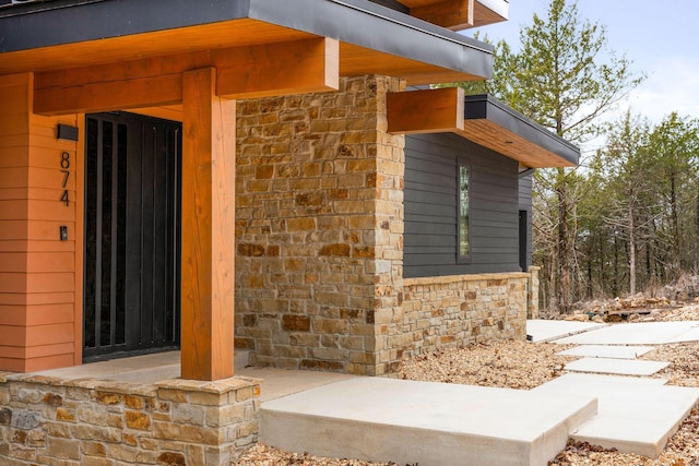 entrance to property with stone siding