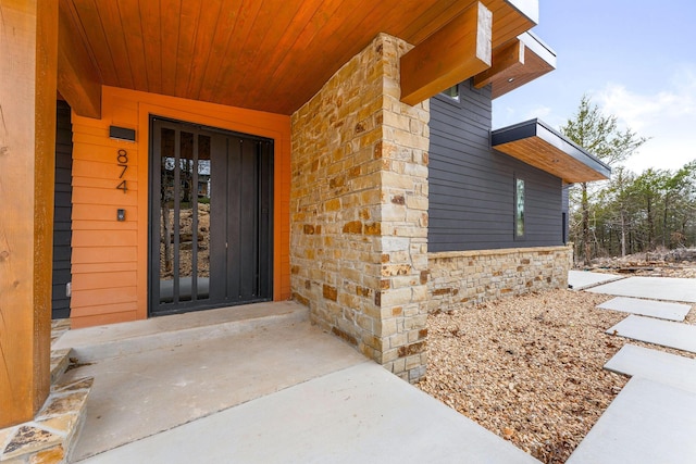 entrance to property with stone siding