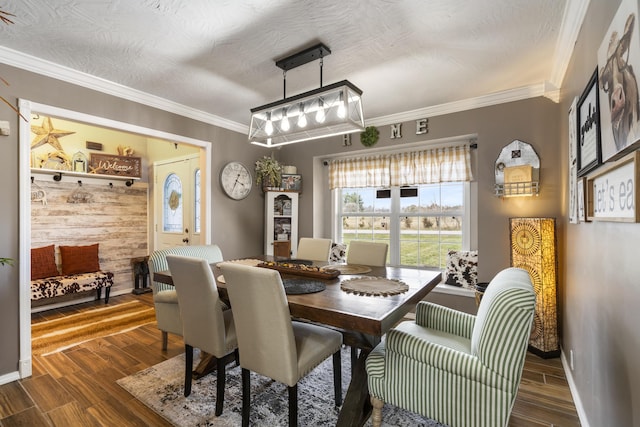 dining room with a textured ceiling, wood finished floors, and ornamental molding