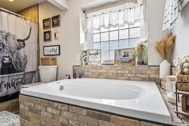 bathroom featuring toilet and a bath