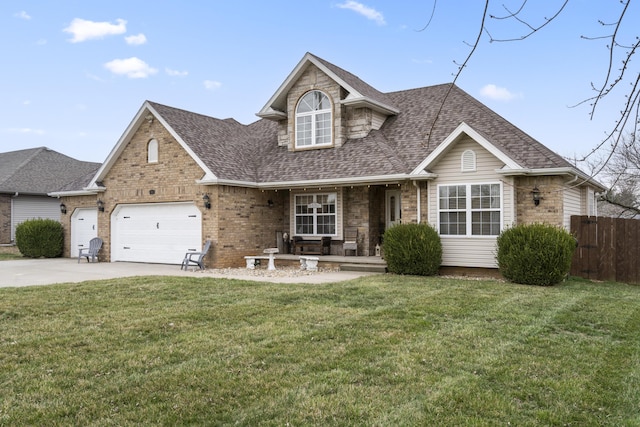 view of front of home with driveway, roof with shingles, a front yard, and fence