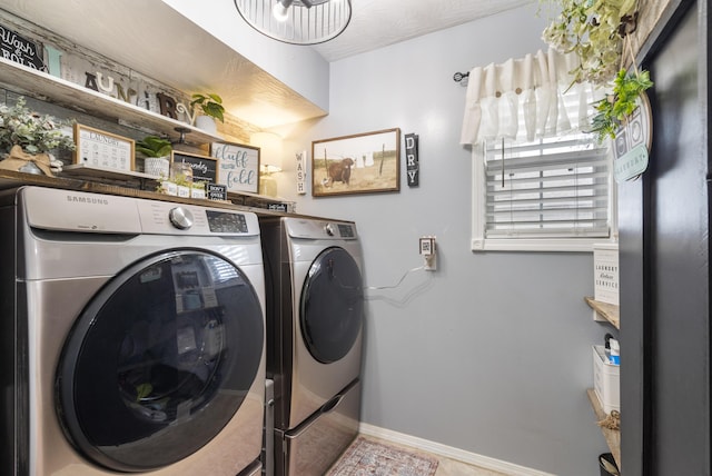 laundry area featuring washer and dryer, laundry area, and baseboards