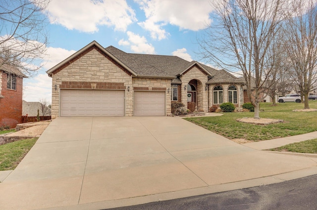 french country inspired facade with a front yard, a garage, driveway, and a shingled roof