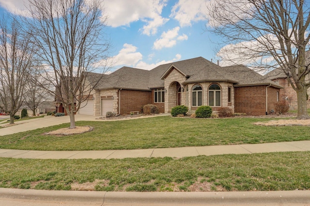 french country inspired facade featuring brick siding, an attached garage, a shingled roof, and a front lawn