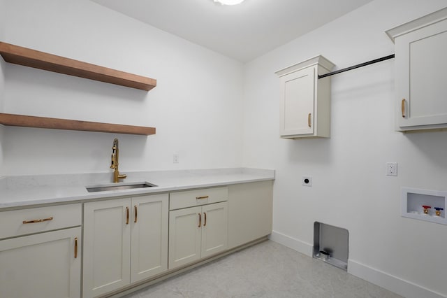 washroom featuring baseboards, cabinet space, electric dryer hookup, washer hookup, and a sink