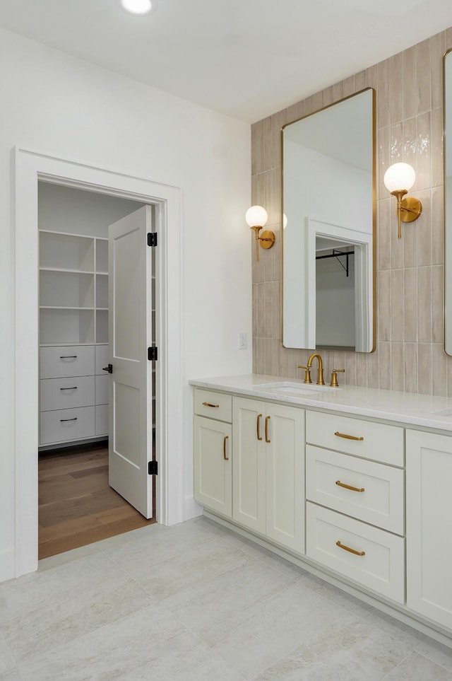 bathroom featuring tasteful backsplash and vanity