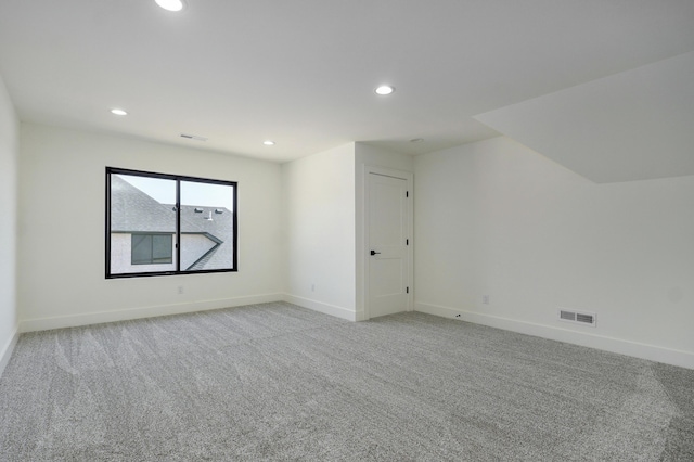 unfurnished room with recessed lighting, baseboards, light carpet, and visible vents