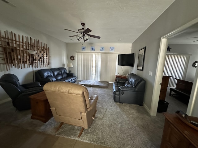 carpeted living room featuring a wealth of natural light, visible vents, and ceiling fan