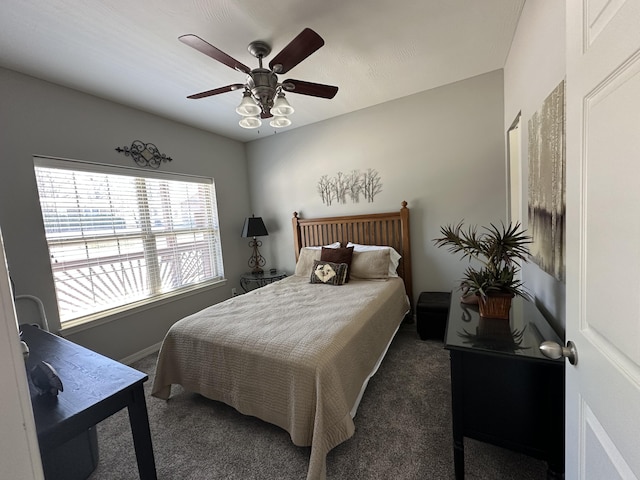 carpeted bedroom featuring baseboards, lofted ceiling, and ceiling fan