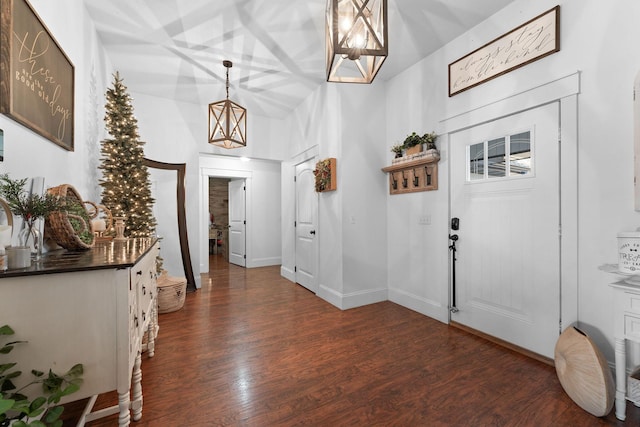 foyer featuring baseboards and dark wood-style floors