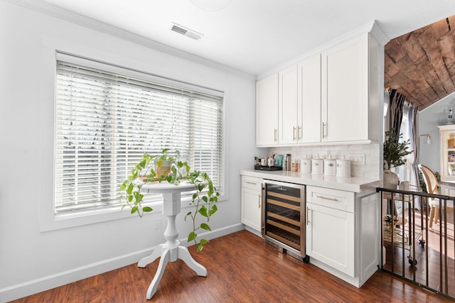 bar with visible vents, baseboards, a bar, dark wood-type flooring, and wine cooler