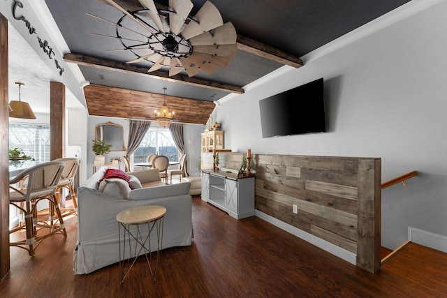 living area featuring beamed ceiling, baseboards, and wood finished floors