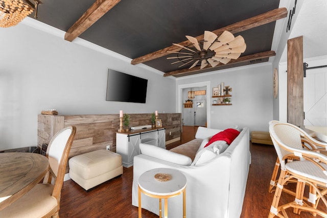 living area with beamed ceiling and wood finished floors