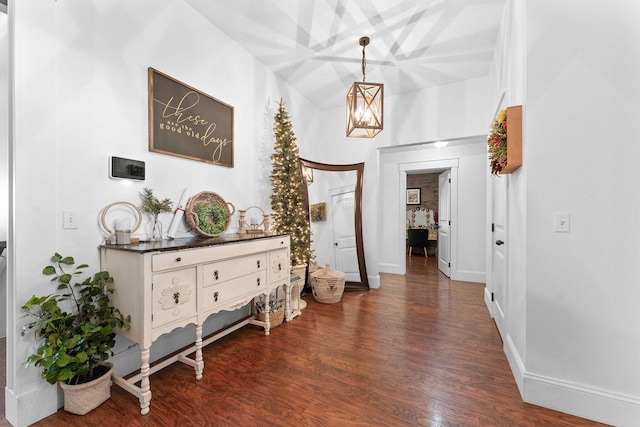 hallway with dark wood finished floors and baseboards