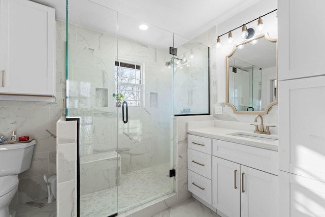 full bathroom featuring a marble finish shower, marble finish floor, toilet, and vanity