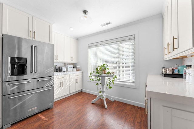 kitchen with crown molding, high quality fridge, visible vents, and dark wood-style flooring