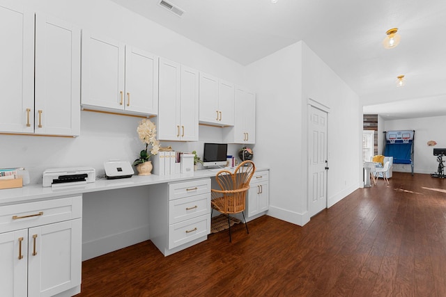 office area with visible vents, built in study area, dark wood-type flooring, and baseboards