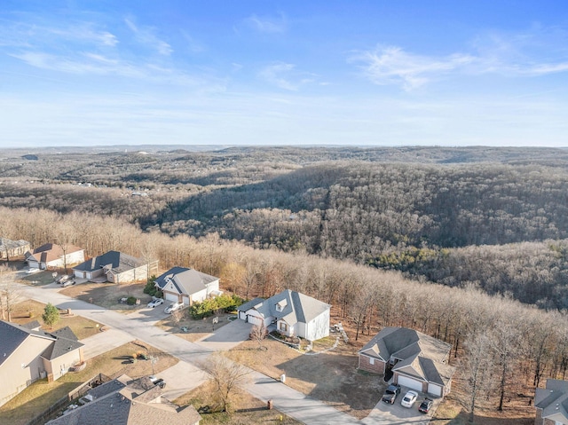 drone / aerial view with a wooded view