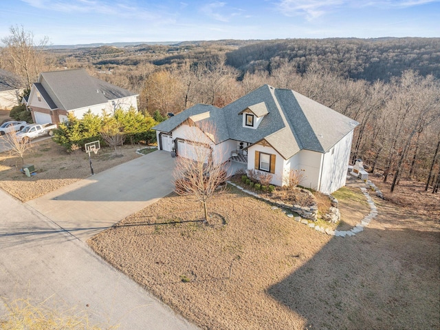 birds eye view of property with a forest view