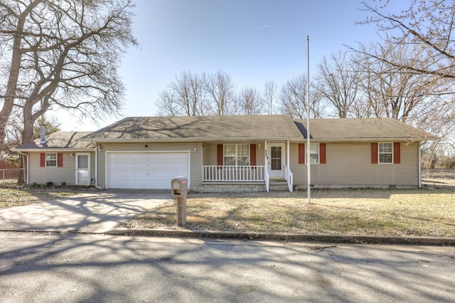 ranch-style house featuring a garage, covered porch, driveway, and crawl space