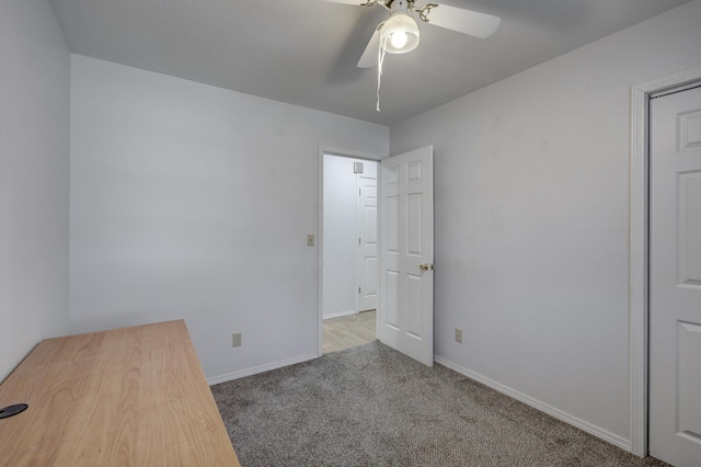 spare room featuring baseboards, a ceiling fan, and carpet flooring