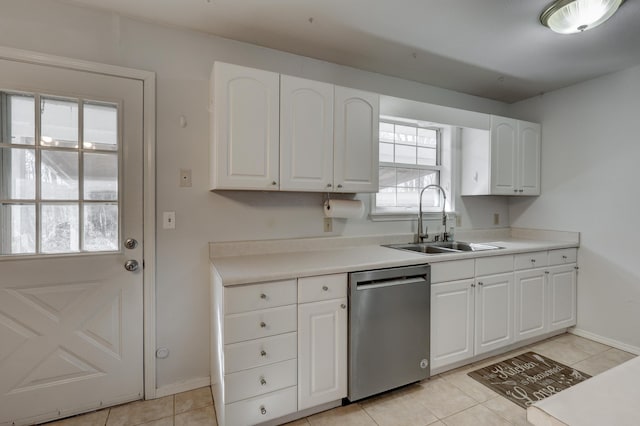 kitchen featuring stainless steel dishwasher, light countertops, white cabinetry, and a sink