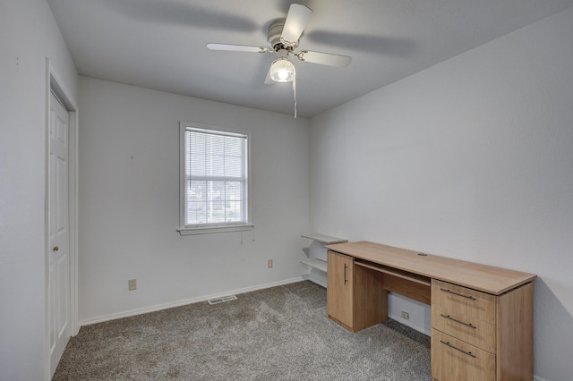 unfurnished office with light carpet, visible vents, baseboards, and ceiling fan