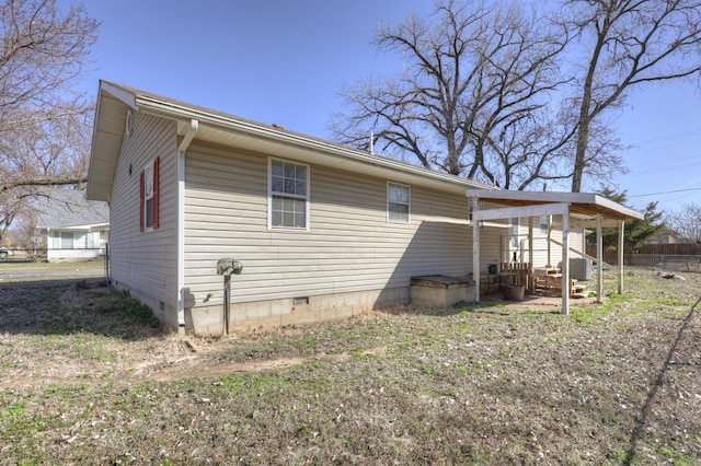 exterior space featuring fence and crawl space