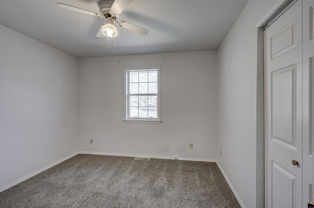 carpeted empty room with visible vents, ceiling fan, and baseboards