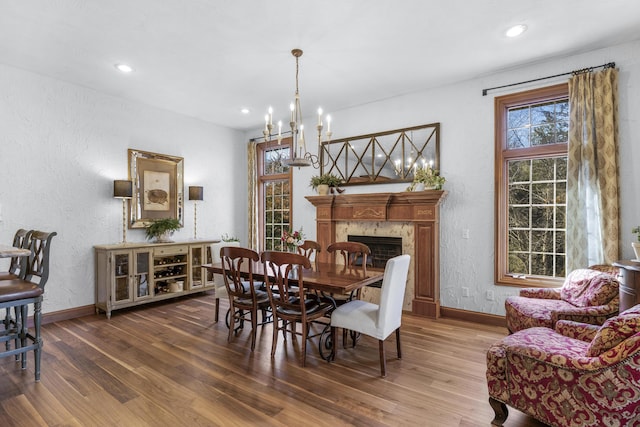 dining space featuring a notable chandelier, wood finished floors, and baseboards