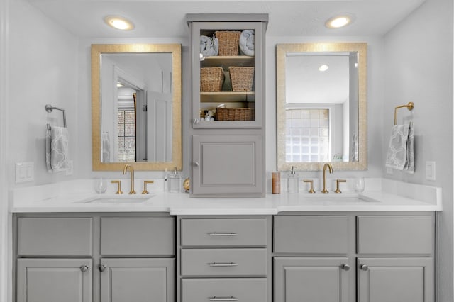 bathroom with a sink and double vanity