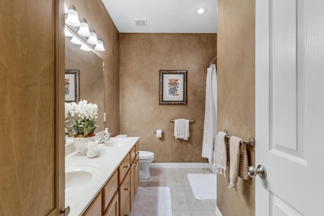 full bathroom featuring tile patterned floors, toilet, a sink, double vanity, and baseboards