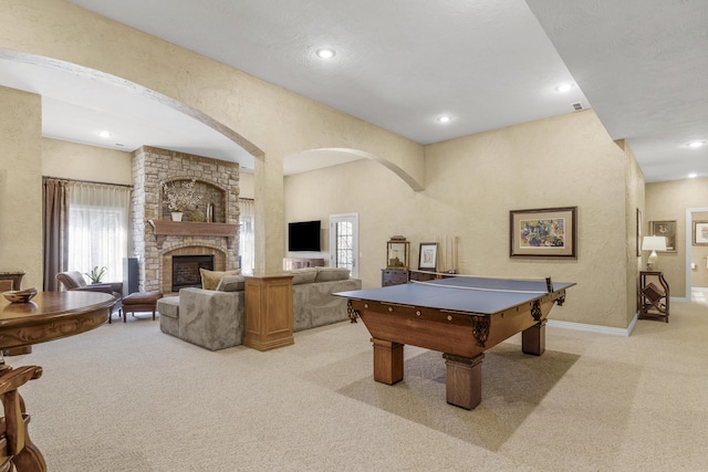 rec room featuring a fireplace, recessed lighting, light colored carpet, and baseboards