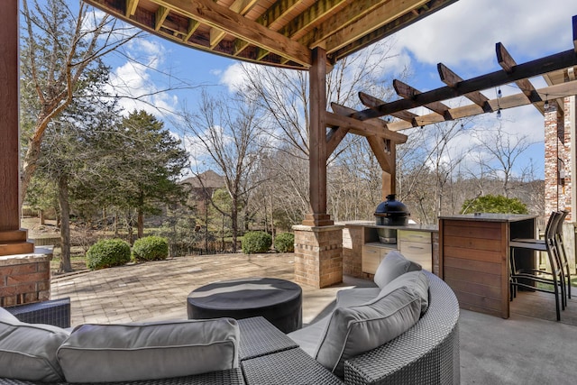 view of patio with a grill, exterior kitchen, outdoor lounge area, and a pergola