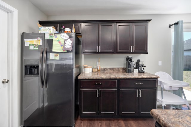 kitchen featuring dark wood-style floors, dark brown cabinets, and stainless steel fridge