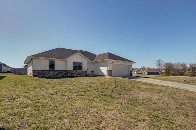 ranch-style home with stone siding, driveway, and a front yard